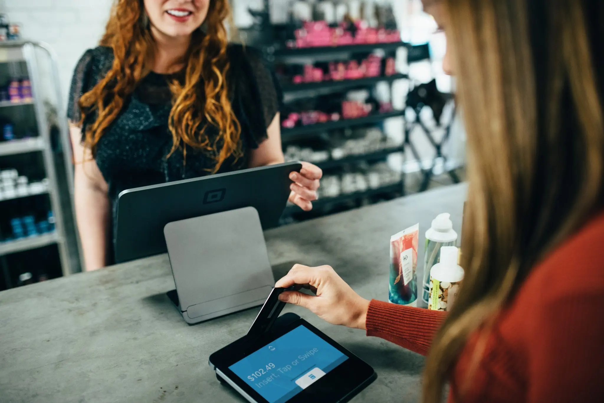 woman paying at digital kiosk