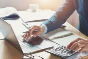 businessman working in office with using calculator and laptop. concept finance and accounting